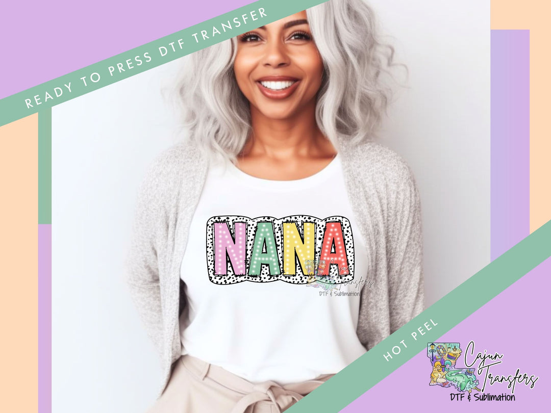 a woman with grey hair wearing a white shirt with the word nama on it