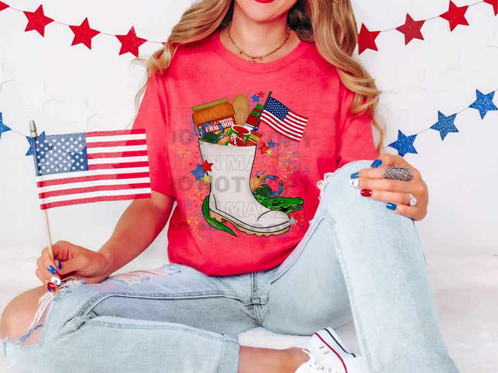 a woman sitting on the ground holding a flag and a t - shirt