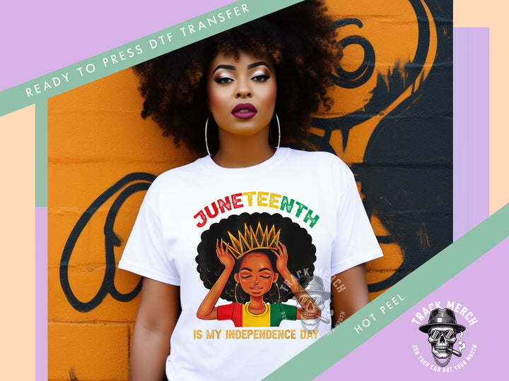 a woman standing in front of a wall wearing a t - shirt