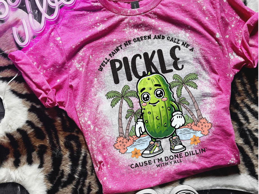 a pink shirt with a pickle on it