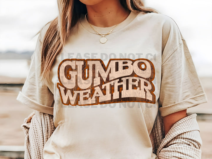 a woman wearing a gumbo weather t - shirt