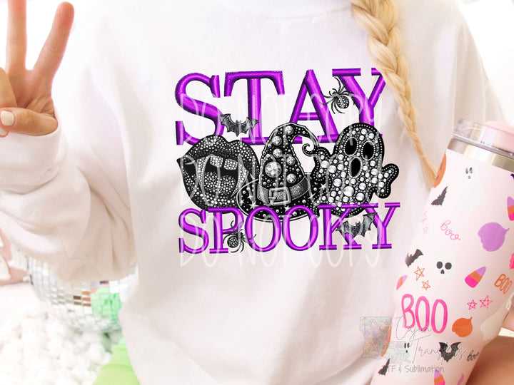 a woman is holding a cup and making a peace sign