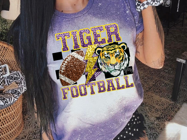 a woman with long hair wearing a tiger football shirt