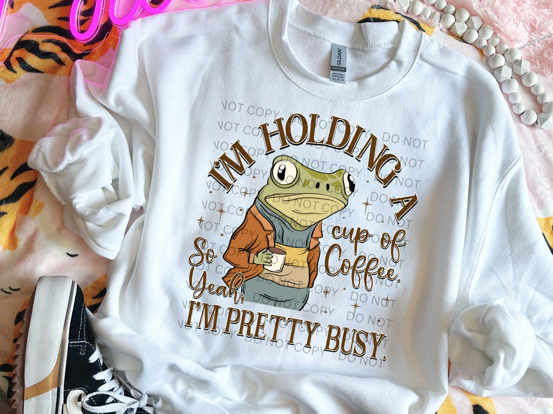 a t - shirt that says i'm holding a cup of coffee and i