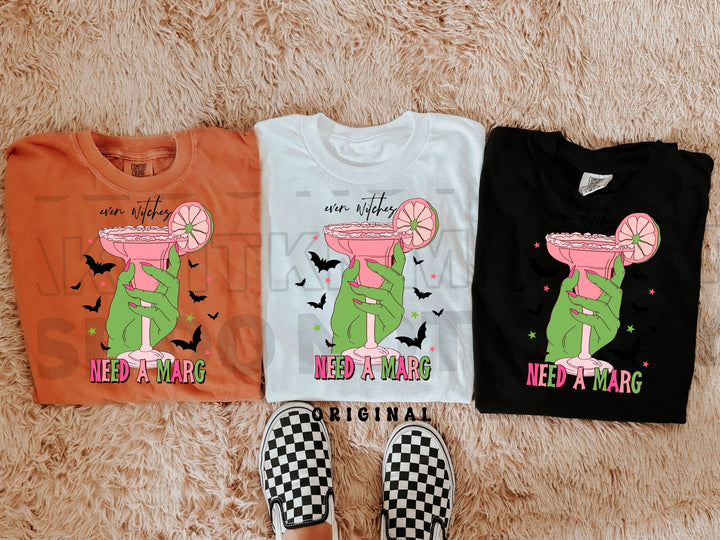 three t - shirts on a carpet with a pair of shoes
