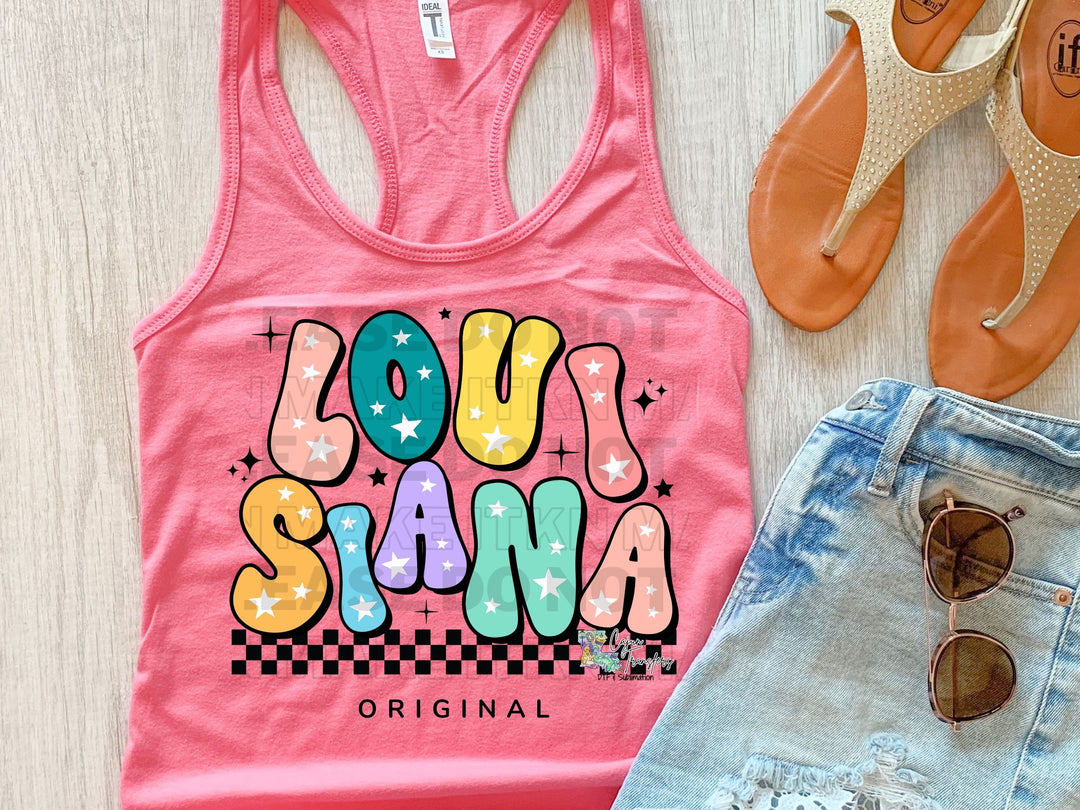 a pair of shorts and a tank top on a table