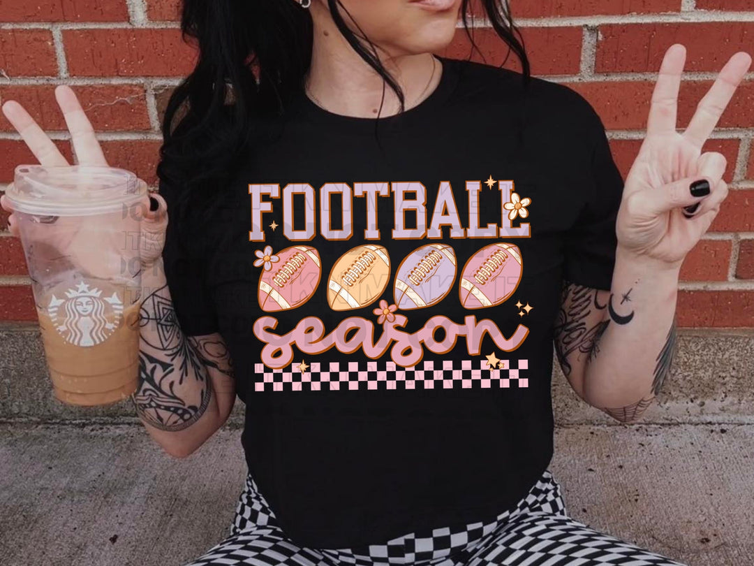 a woman sitting on the ground holding a cup of coffee