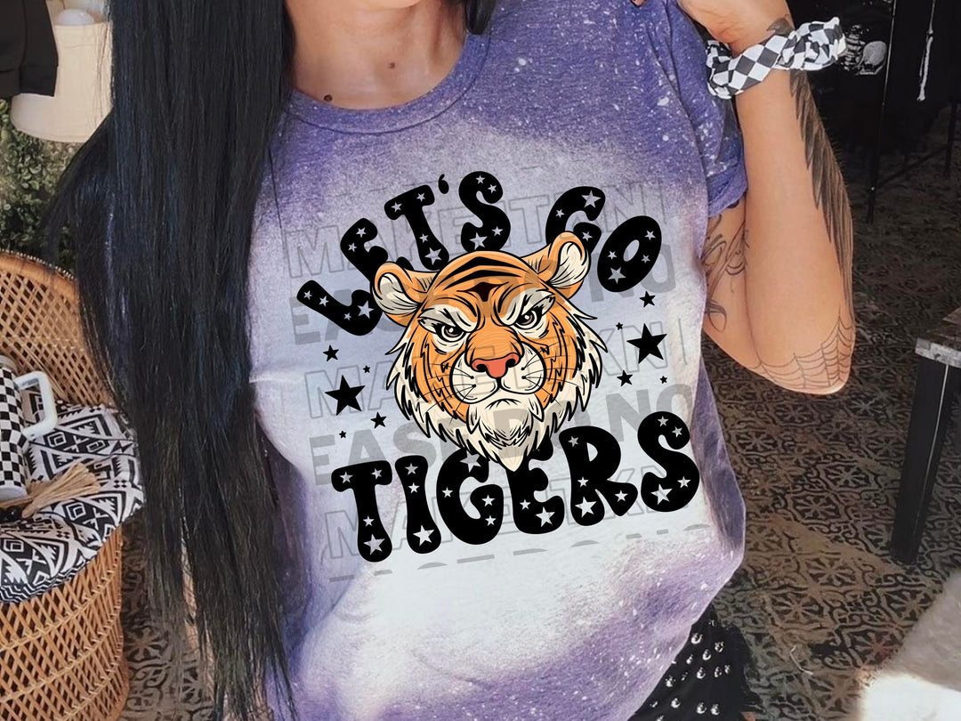 a woman wearing a purple tshirt with a tiger on it