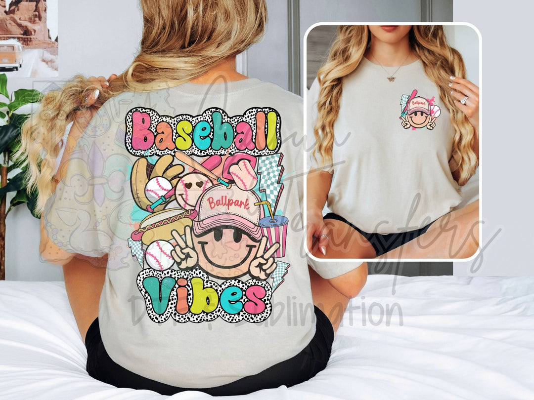a woman sitting on a bed wearing a baseball vibe shirt