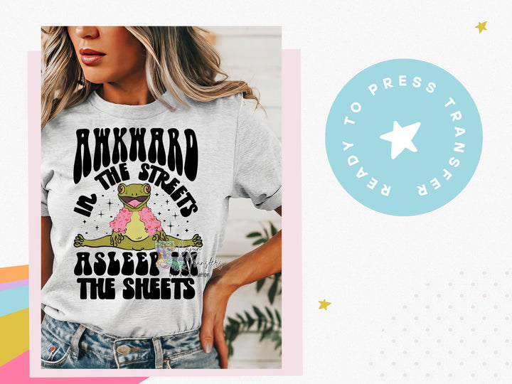 a woman wearing a t - shirt that says awkward in the sheets