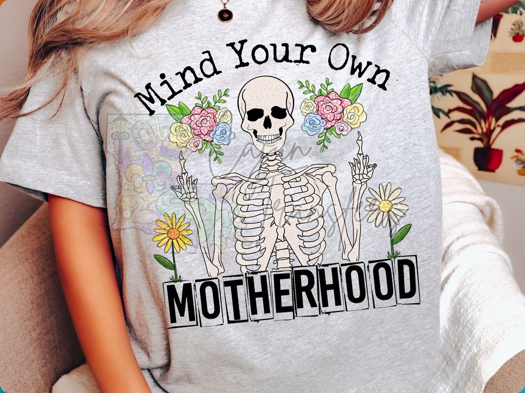 a girl wearing a t - shirt that says mind your own motherhood