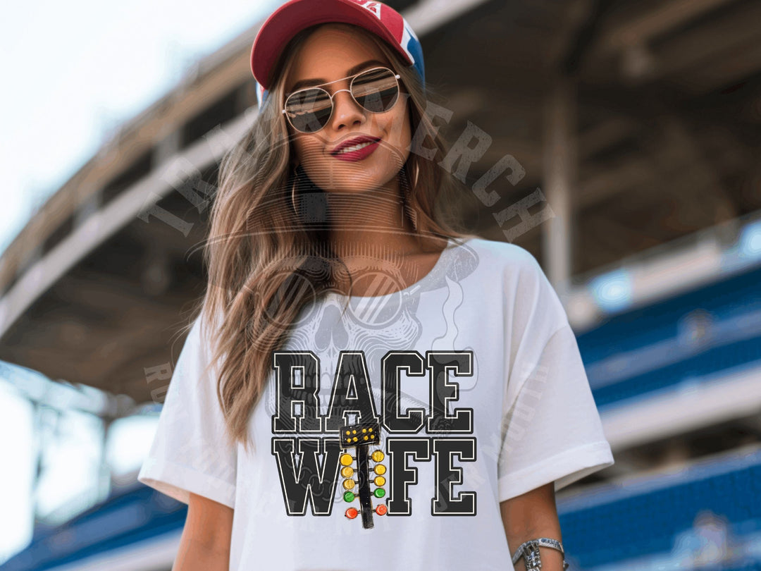 a woman wearing a race wife t - shirt and sunglasses