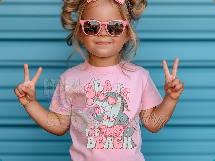 a little girl wearing sunglasses and a pink shirt