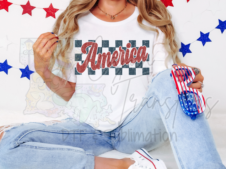 a woman sitting on the ground with a american shirt on