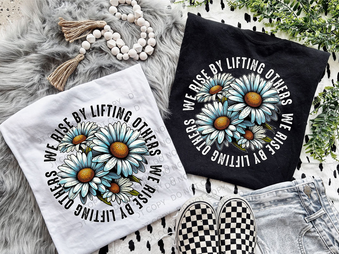 a pair of t - shirts with daisies on them