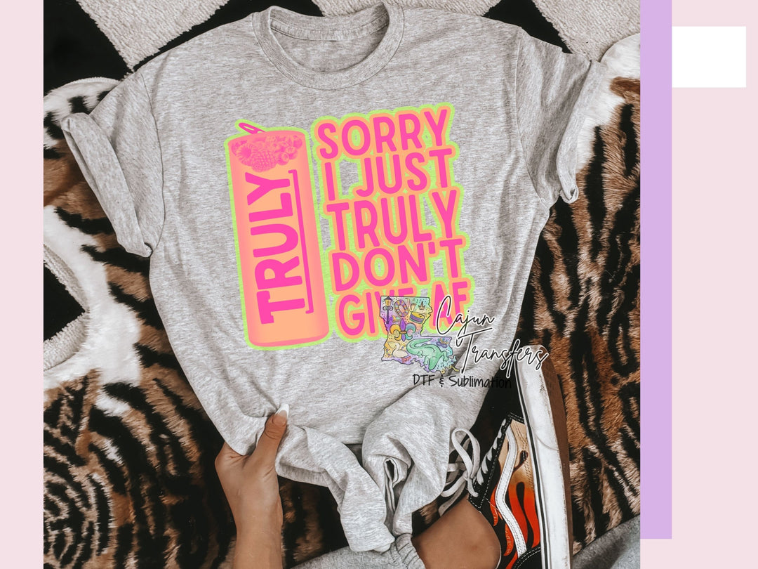 a woman is holding a t - shirt that says sorry i just truly don '