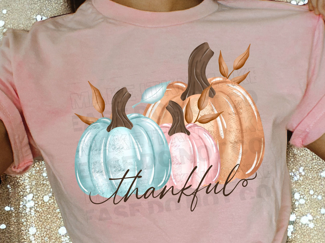 a woman wearing a pink shirt with two pumpkins on it