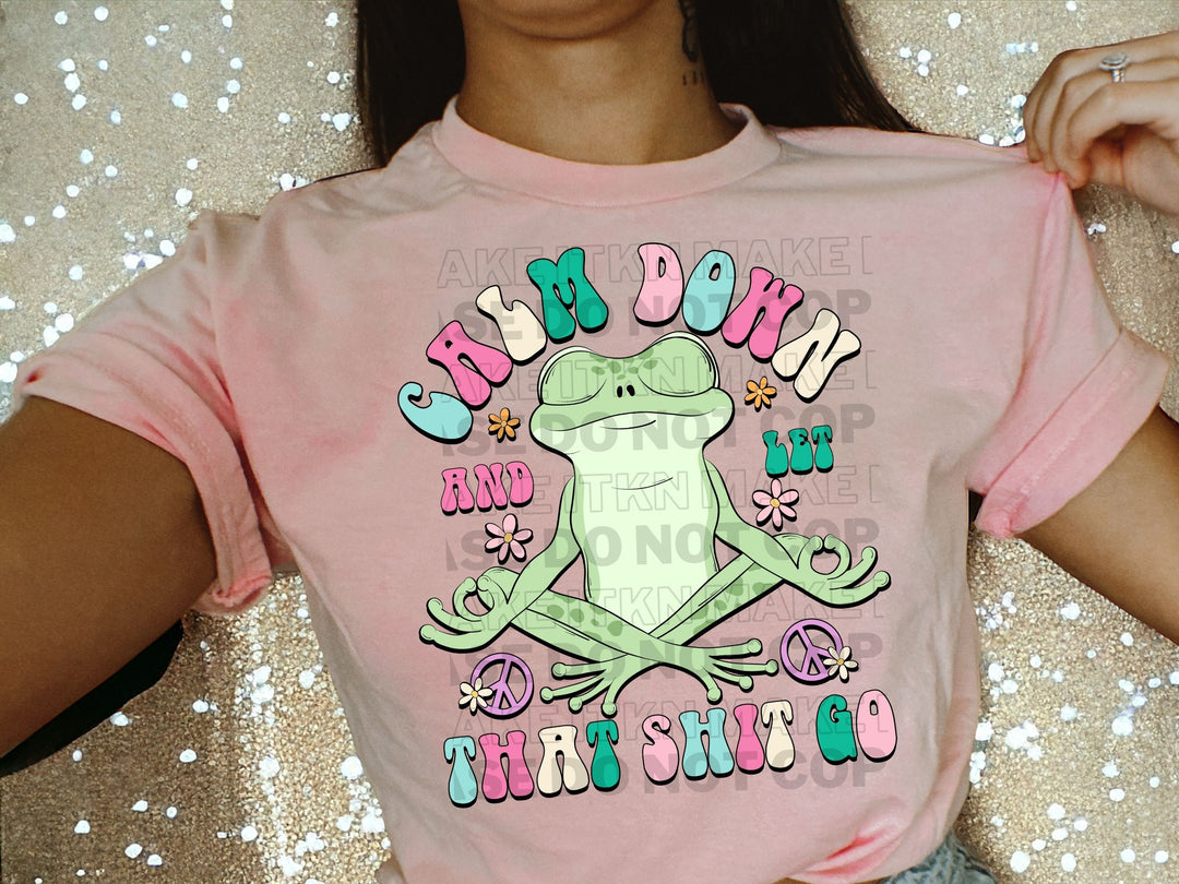 a woman wearing a pink shirt with a frog on it